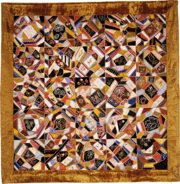 A crazy quilt — irregular with a riot of color, stitching, fabric, and detail.