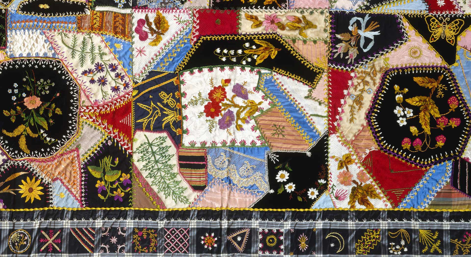 Detail of the above quilt, highlighting the embroidery and exotic stitchwork.