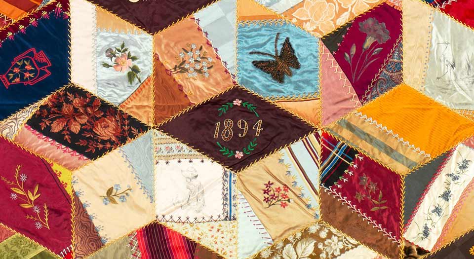 Detail of the above quilt, zooming in on the diamond embroidered with “1884”. Lots of butterflies and flowers.